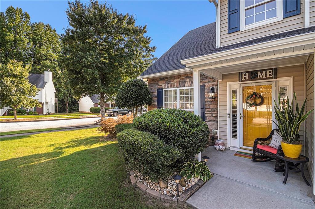 a view of a house with backyard porch and sitting area