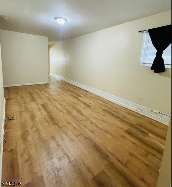 544 Broadway, Unit 1 Elizabeth Port, NJ 07206 - Photo 2 of 7 en empty room with wooden floor