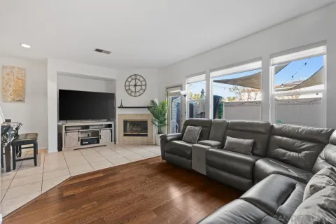 a living room with furniture a fireplace and a flat screen tv