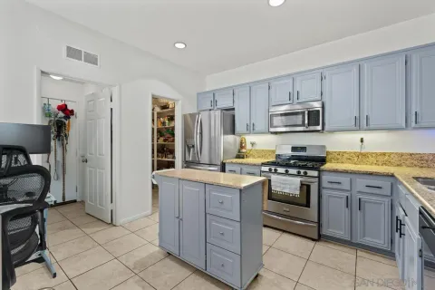a kitchen with a refrigerator stove top oven and sink