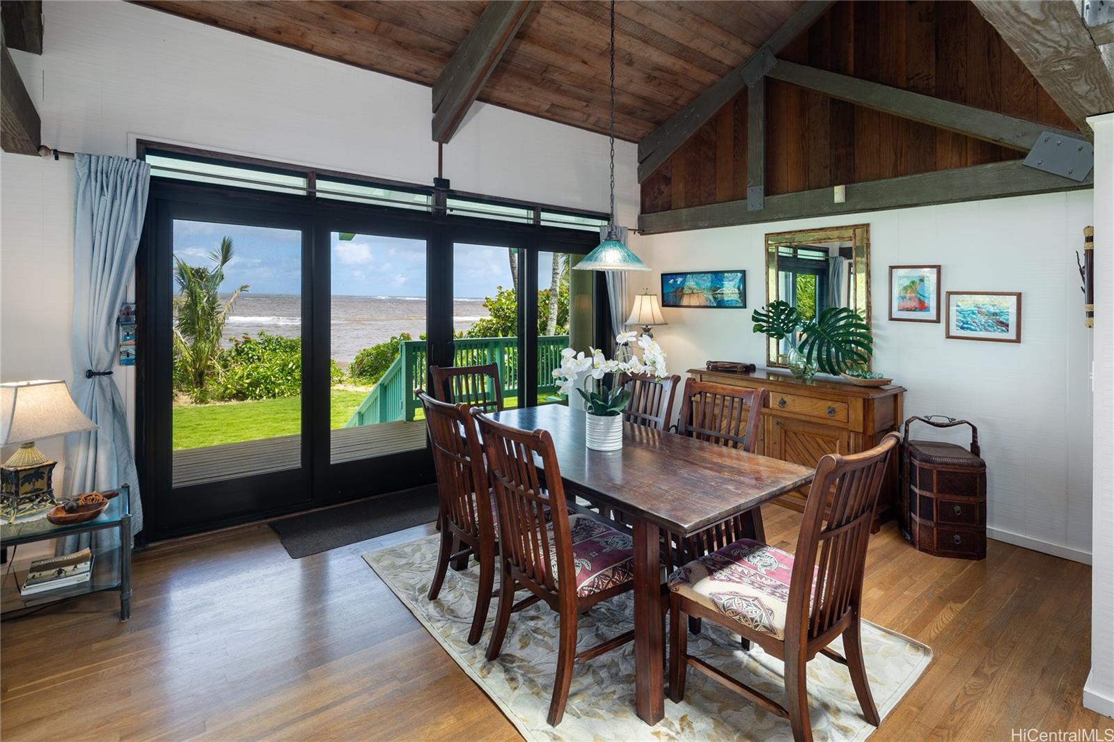 67-421 Waialua Beach Road Waialua, HI 96791 - Photo 11 of 25 a view of a dining room with furniture window and wooden floor
