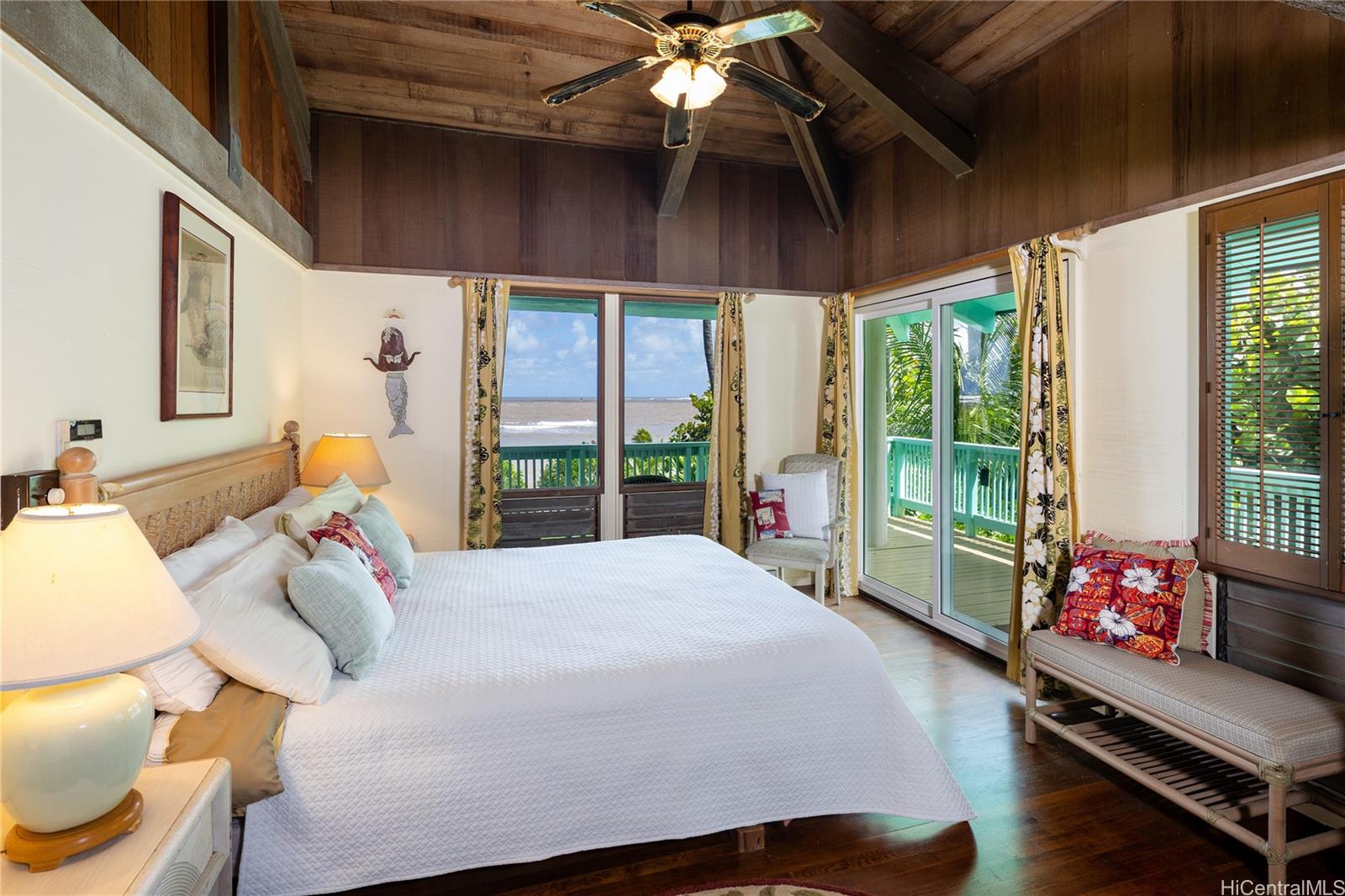 67-421 Waialua Beach Road Waialua, HI 96791 - Photo 14 of 25 a bedroom with a bed and large windows