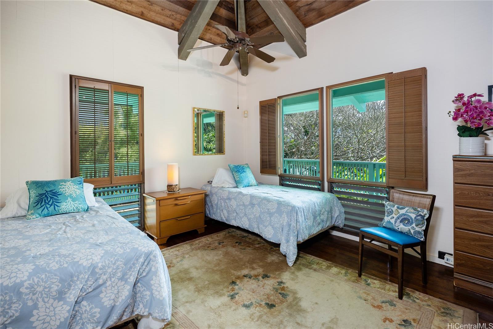 67-421 Waialua Beach Road Waialua, HI 96791 - Photo 17 of 25 a bedroom with a bed and a chandelier