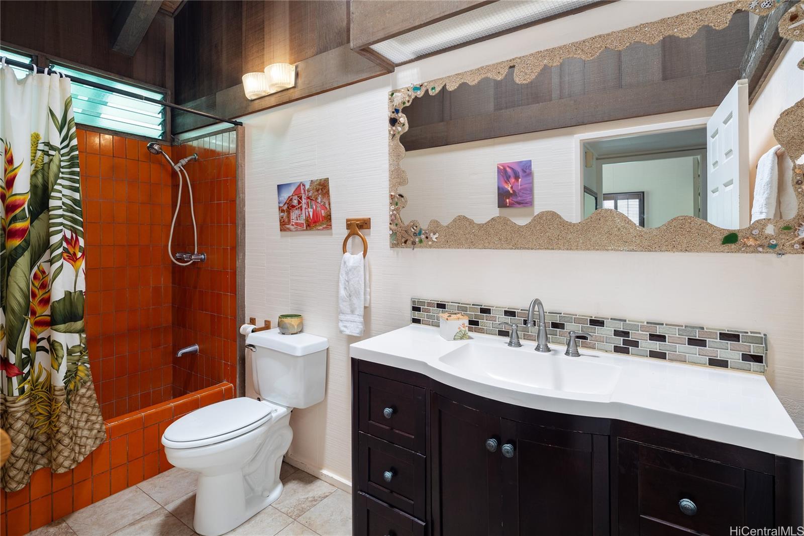 67-421 Waialua Beach Road Waialua, HI 96791 - Photo 18 of 25 a bathroom with a sink vanity mirror and toilet