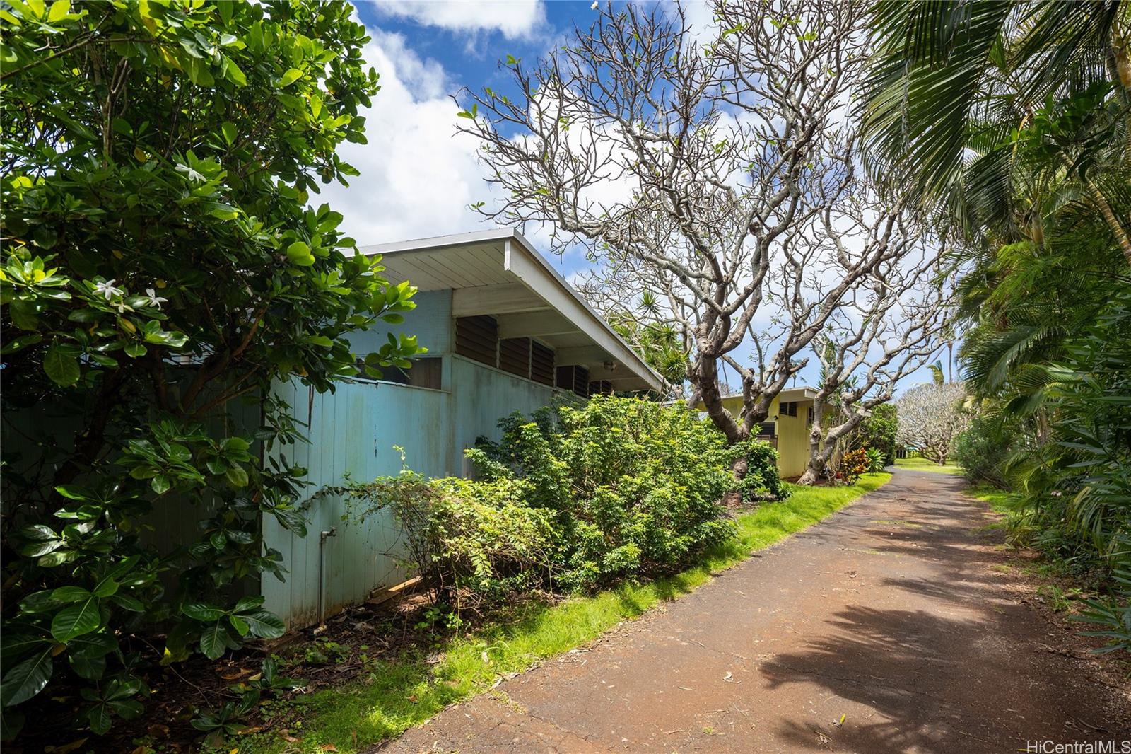 67-421 Waialua Beach Road Waialua, HI 96791 - Photo 22 of 25 a front view of a house with a yard and fountain in middle