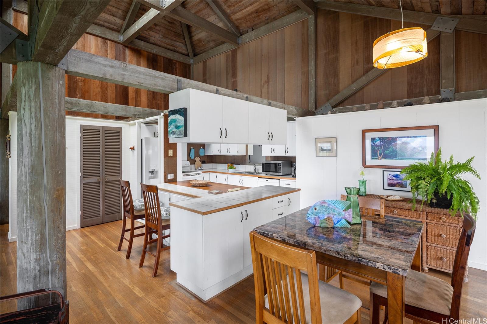 67-421 Waialua Beach Road Waialua, HI 96791 - Photo 8 of 25 a kitchen that has a table and chairs in it