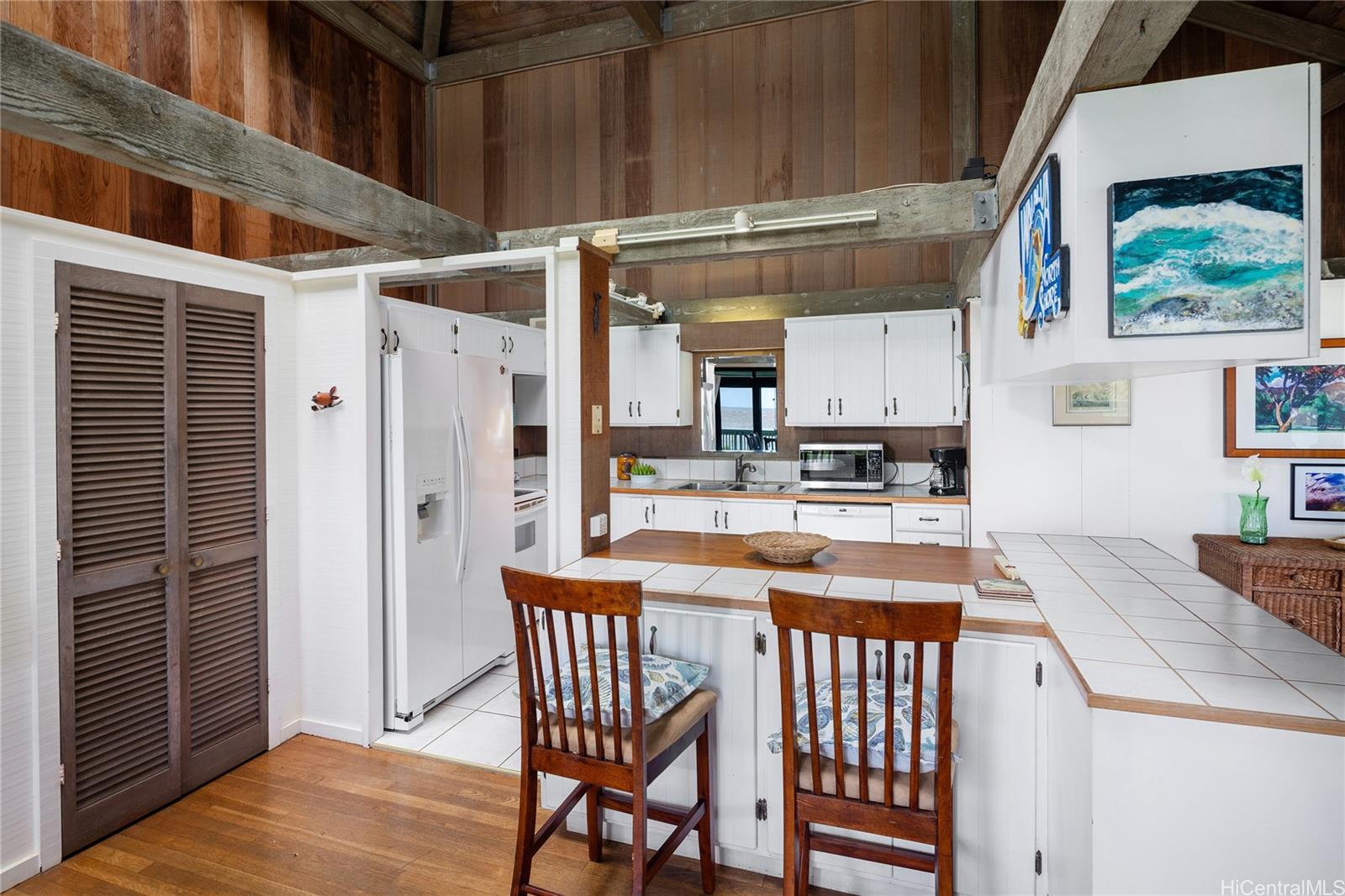 67-421 Waialua Beach Road Waialua, HI 96791 - Photo 9 of 25 a kitchen with stainless steel appliances granite countertop a stove a sink and a refrigerator