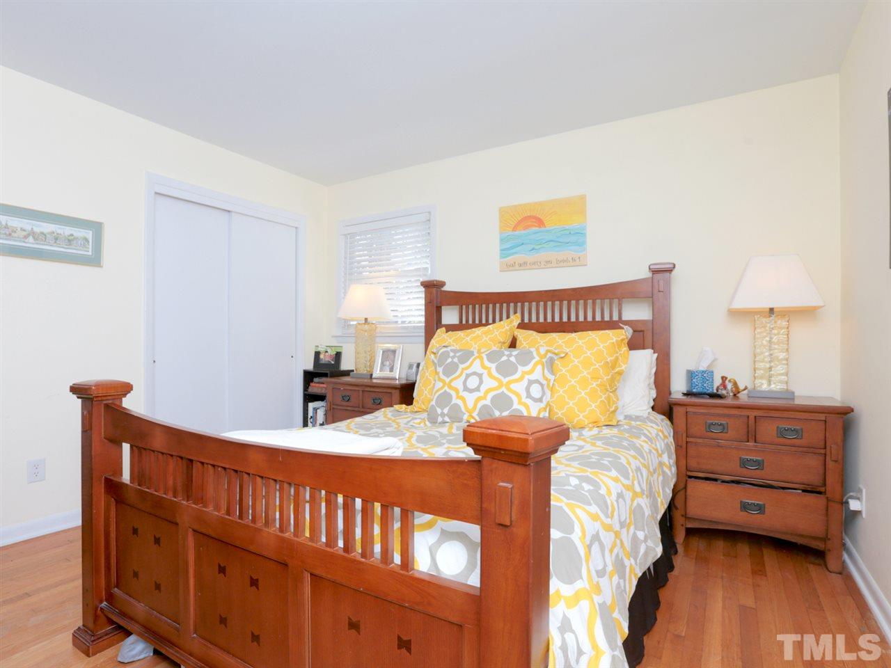 403 Kevin Circle Raleigh, NC 27609 - Photo 15 of 25 a bedroom with furniture and a wooden floor