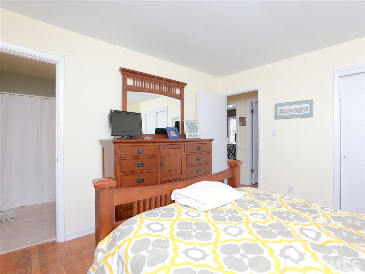 403 Kevin Circle Raleigh, NC 27609 - Photo 16 of 25 a bedroom with a bed and a dresser