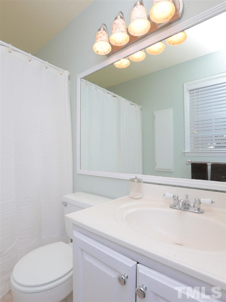 403 Kevin Circle Raleigh, NC 27609 - Photo 17 of 25 a bathroom with a sink a toilet and a mirror