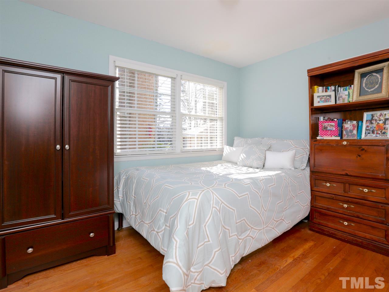 403 Kevin Circle Raleigh, NC 27609 - Photo 18 of 25 a bed sitting in a bedroom next to a cabinet
