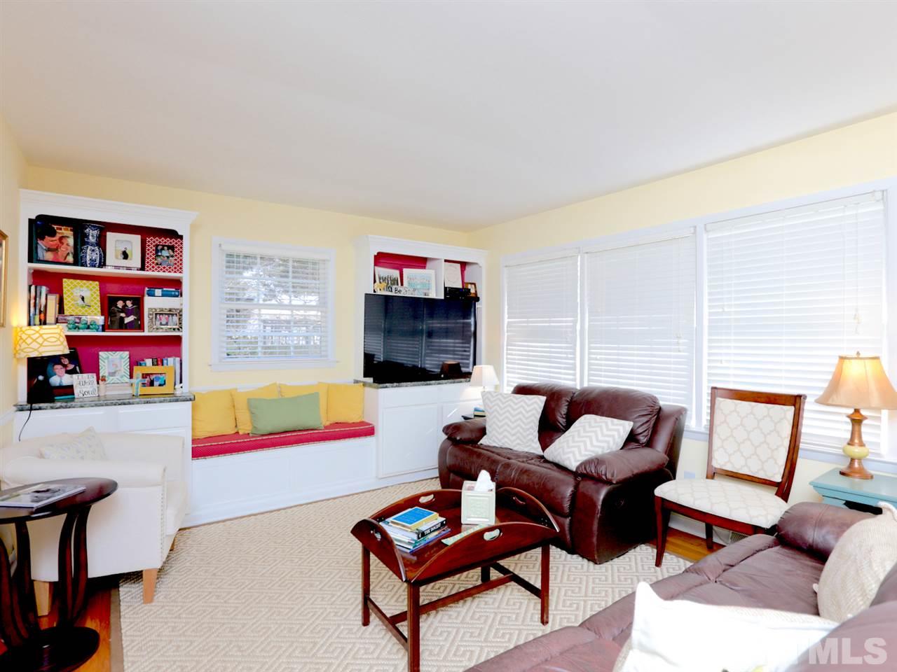 403 Kevin Circle Raleigh, NC 27609 - Photo 5 of 25 a living room with furniture a rug and a wall painting