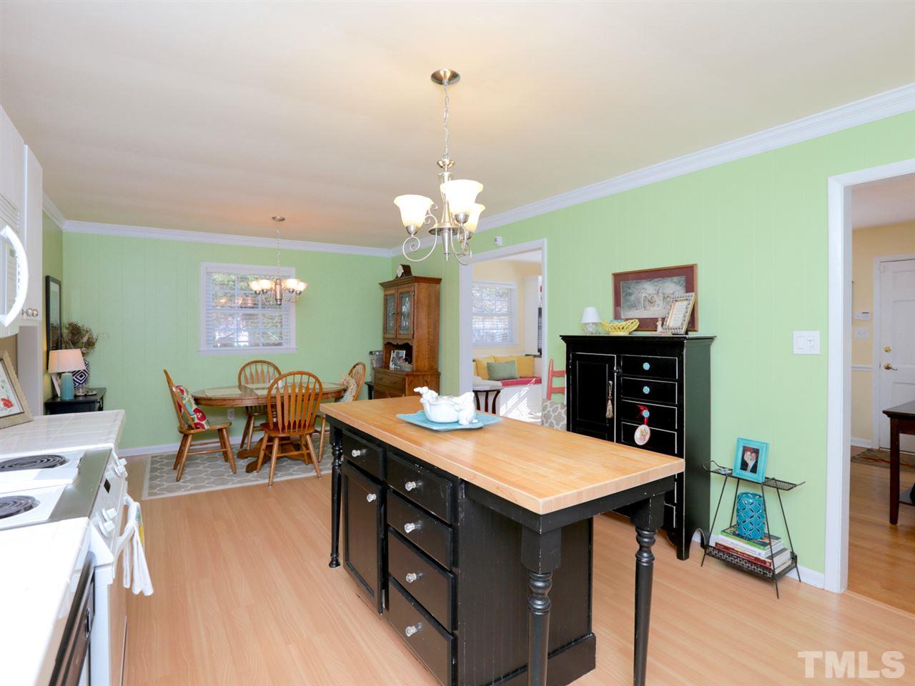 403 Kevin Circle Raleigh, NC 27609 - Photo 8 of 25 a view of a dining room with furniture and wooden floor
