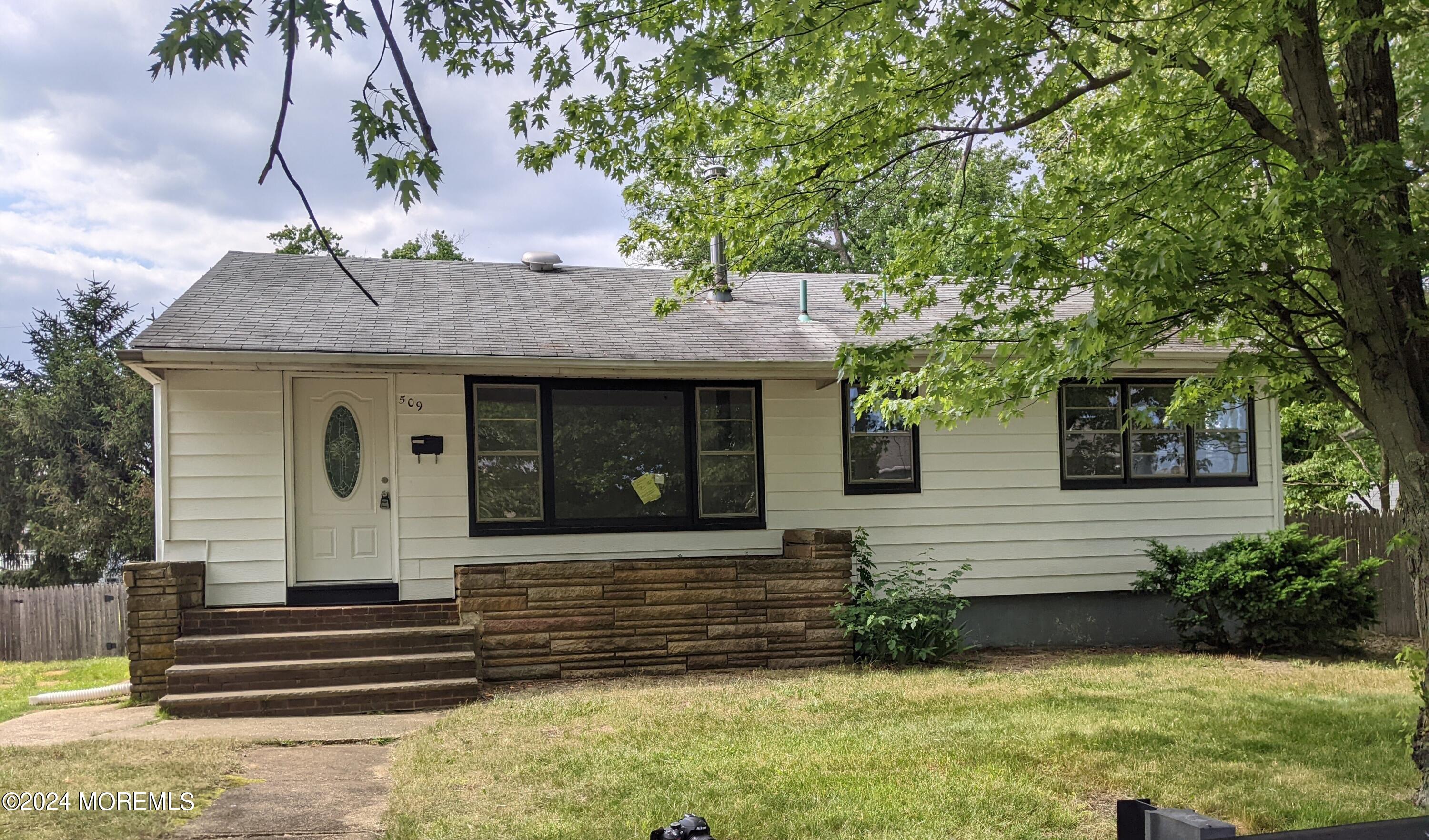 509 Stone Road Union Beach, NJ 07735 - Photo 1 of 16 a front view of a house with garden