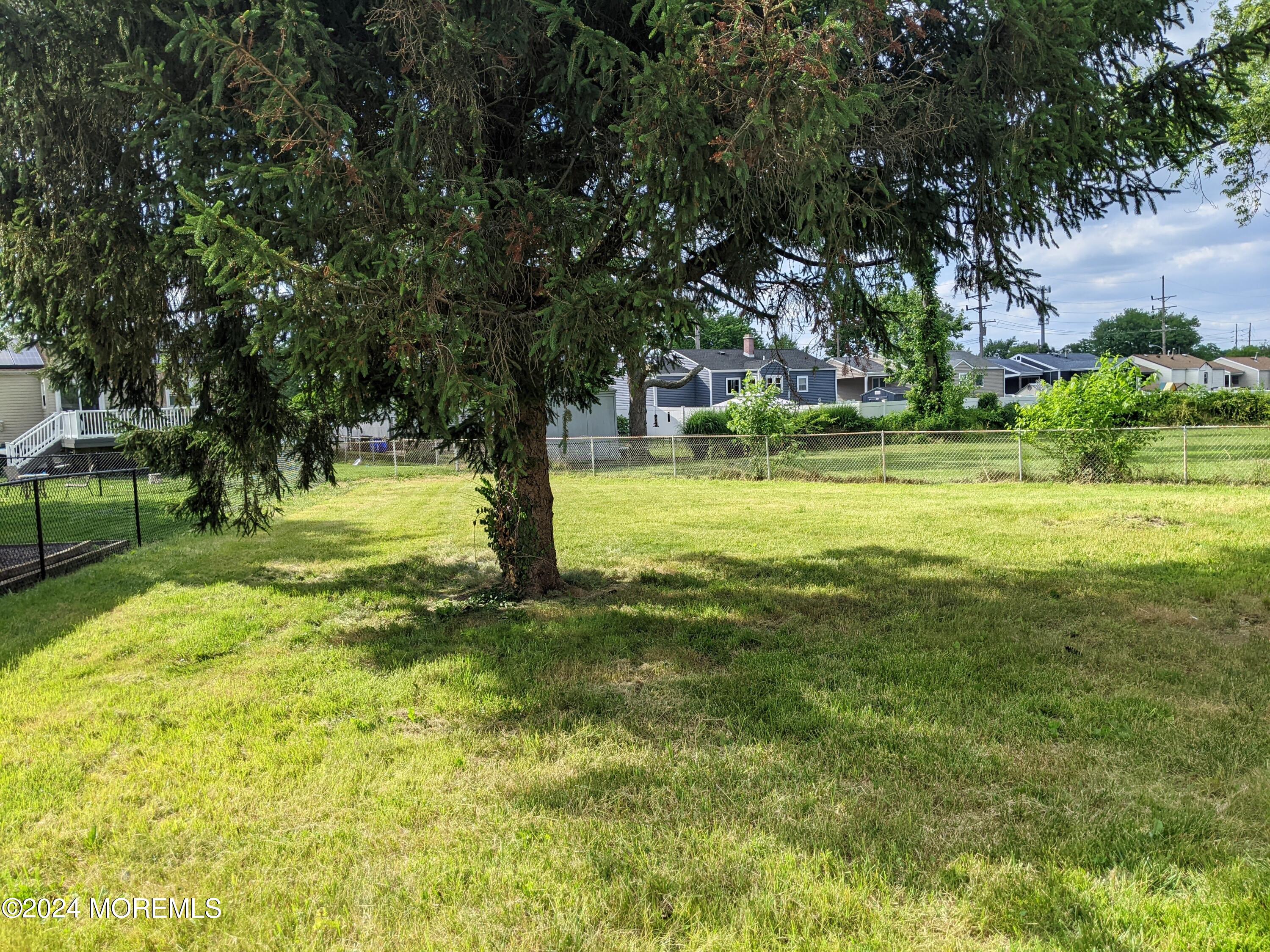 509 Stone Road Union Beach, NJ 07735 - Photo 13 of 16 a view of a trees with a big yard
