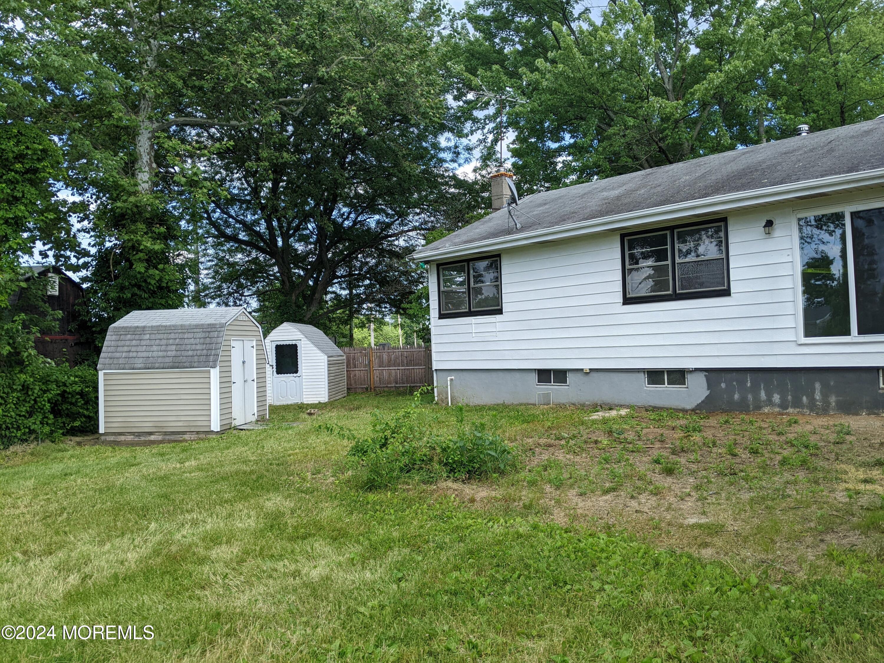509 Stone Road Union Beach, NJ 07735 - Photo 16 of 16 a house that has a tree in front of it