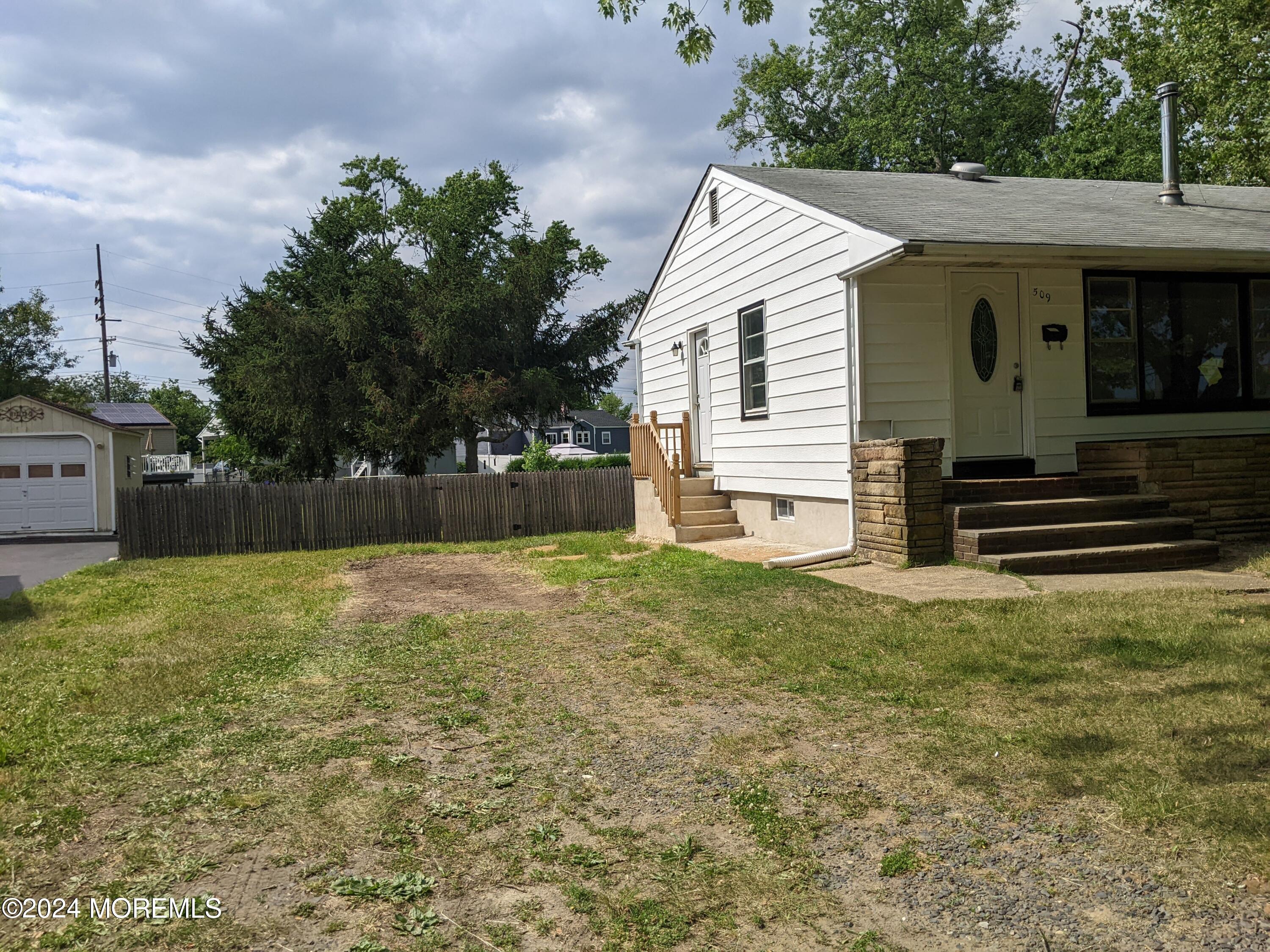 509 Stone Road Union Beach, NJ 07735 - Photo 2 of 16 a backyard of a house with lots of green space