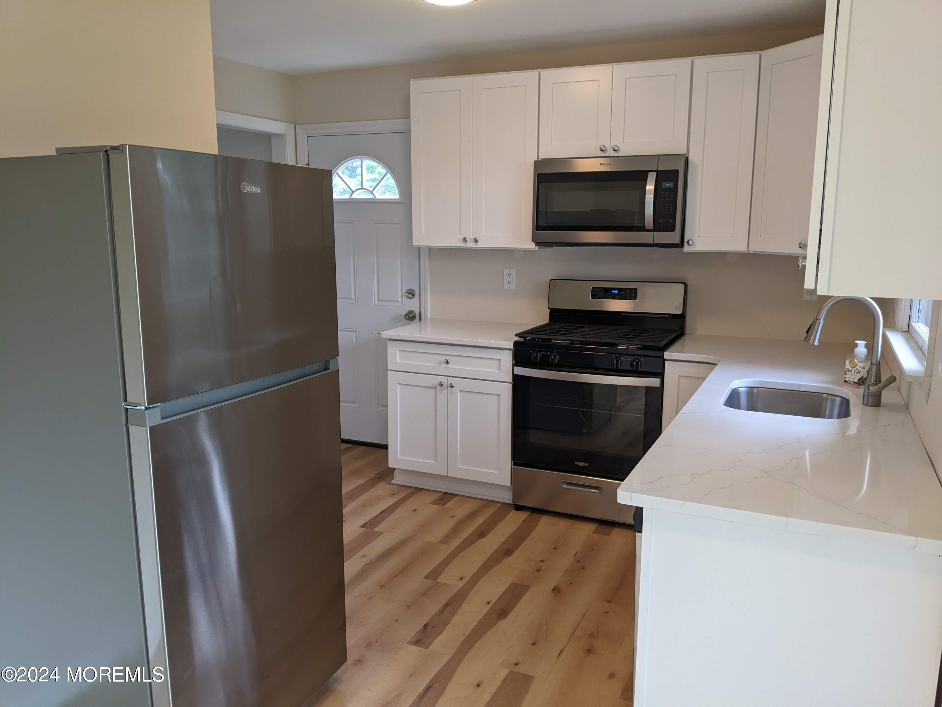 509 Stone Road Union Beach, NJ 07735 - Photo 3 of 16 a kitchen with stainless steel appliances granite countertop a refrigerator a stove top oven a sink and dishwasher