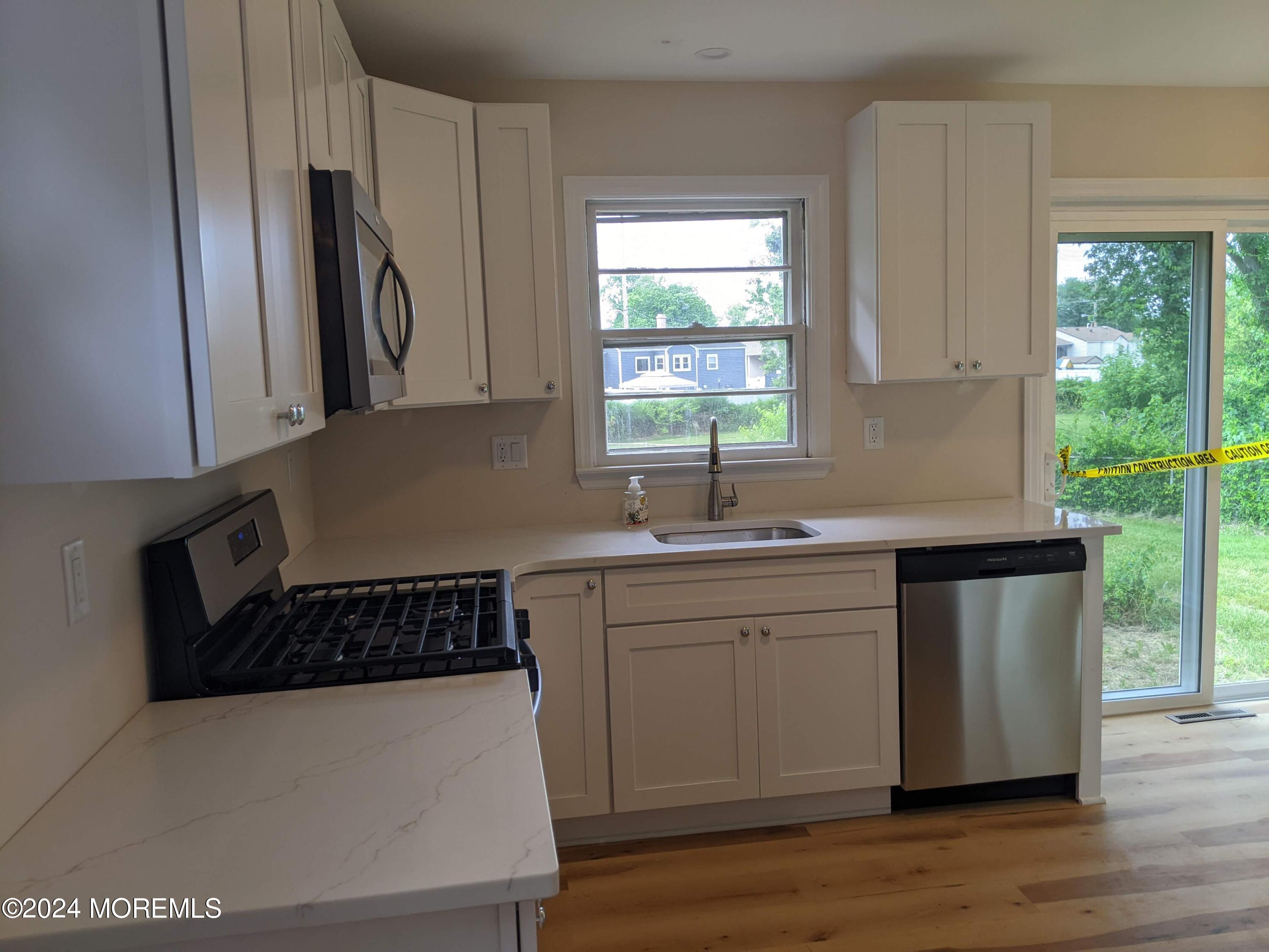 509 Stone Road Union Beach, NJ 07735 - Photo 4 of 16 a kitchen with sink a window and stainless steel appliances