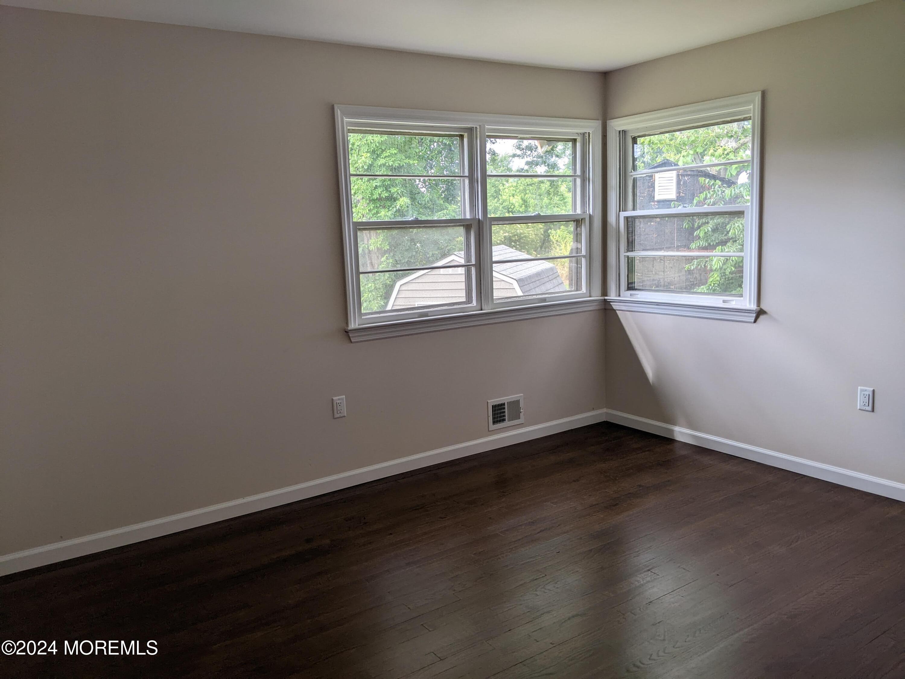 509 Stone Road Union Beach, NJ 07735 - Photo 10 of 16 an empty room with wooden floor and windows