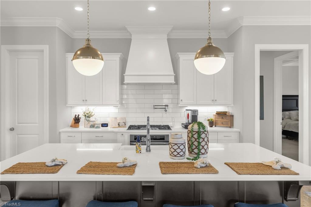 4262 Bridgehead Road Kernersville, NC 27284 - Photo 12 of 50 Kitchen Detail – A chef’s dream with a gas cooktop, pot-filler, farmhouse sink, and quartz countertops offering both beauty and functionality.