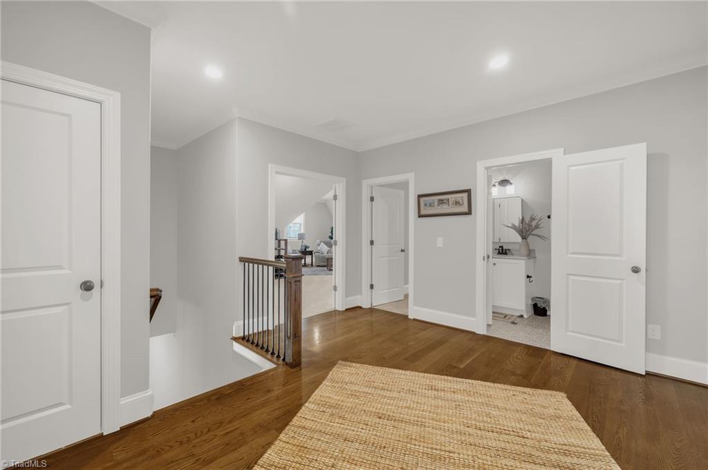 4262 Bridgehead Road Kernersville, NC 27284 - Photo 24 of 50 Upstairs Landing – Spacious upper hallway with hardwood floors and access to multiple bedrooms, full bath, and versatile bonus spaces.