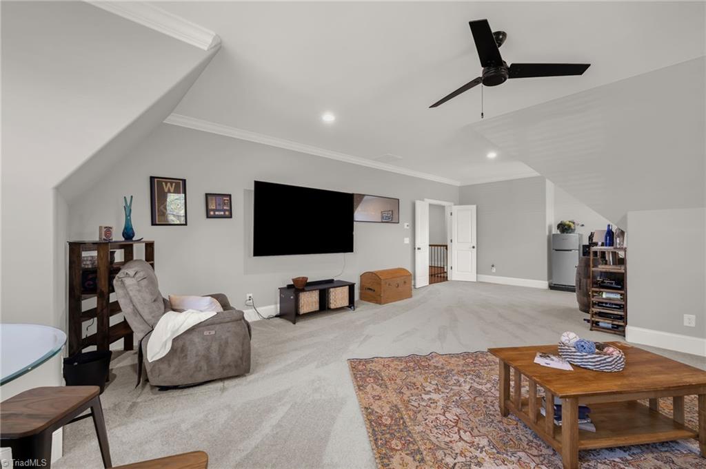4262 Bridgehead Road Kernersville, NC 27284 - Photo 34 of 50 Alternate view of the upstairs bonus room showcasing its spacious layout, plush carpeting, and open flow — perfect for a home theater, playroom, or hobby space.