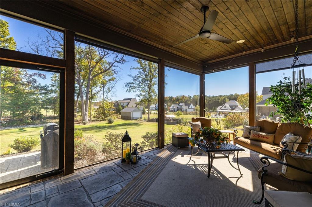 4262 Bridgehead Road Kernersville, NC 27284 - Photo 37 of 50 Screened Porch View – Relax year-round in the screened porch with a wood ceiling, ceiling fan, and sweeping views of the private backyard and neighboring pastures.