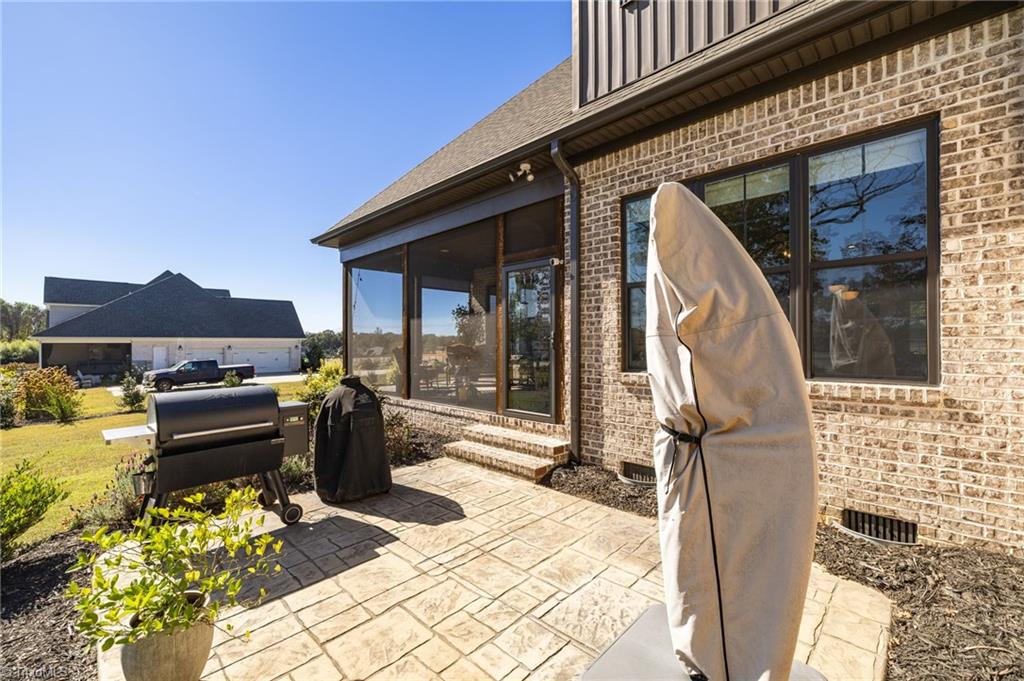 4262 Bridgehead Road Kernersville, NC 27284 - Photo 39 of 50 Patio & Grill Area – Step outside to a stamped-concrete patio ideal for grilling and entertaining, easily accessible from the main living spaces.