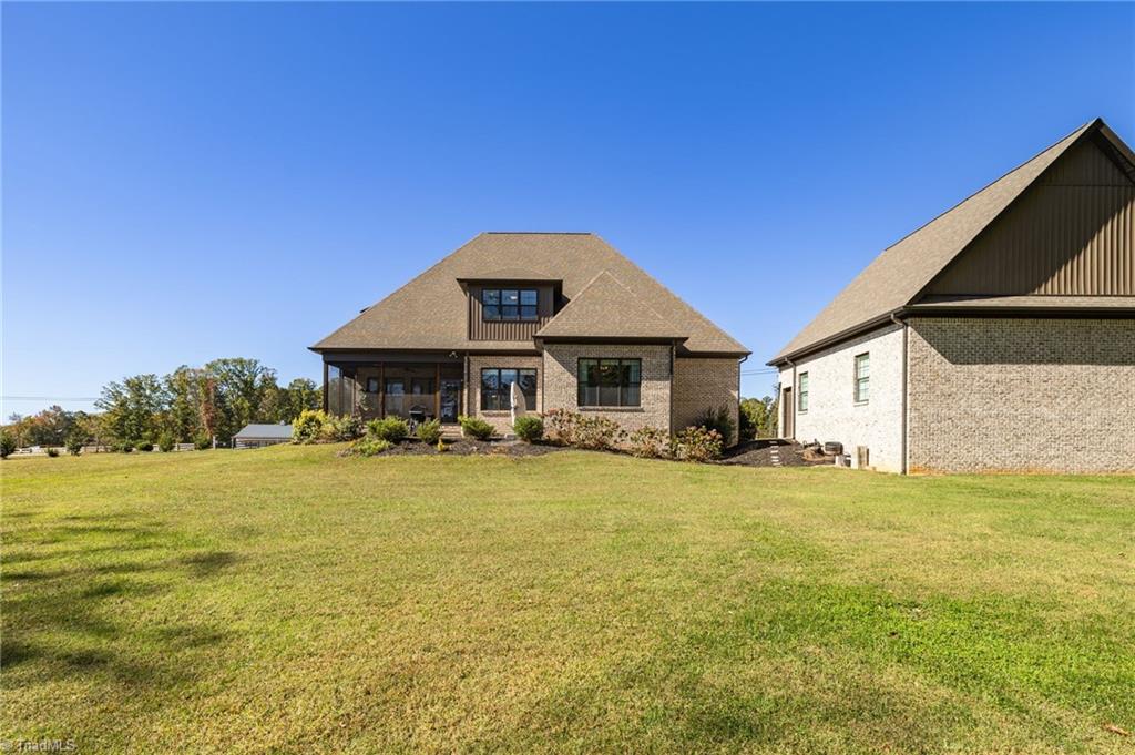 4262 Bridgehead Road Kernersville, NC 27284 - Photo 42 of 50 Property View – Level, usable yard space surrounded by natural beauty—ideal for play, gardening, or future pool addition.