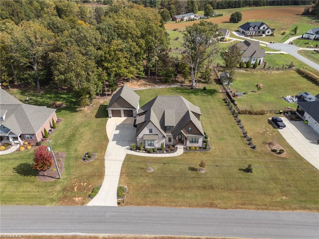 4262 Bridgehead Road Kernersville, NC 27284 - Photo 46 of 50 Aerial Front View – Impressive overhead view showcasing the home’s curb appeal, spacious driveway, and detached garage on a large, manicured lot.