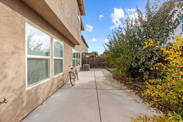a view of a porch with furniture and a yard