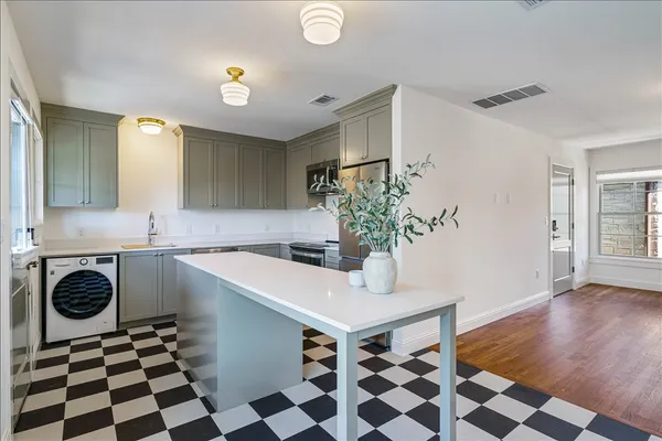 a kitchen with a sink and a washer dryer