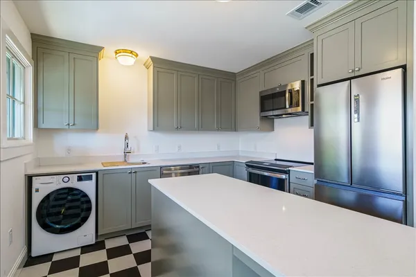 a kitchen with a sink and cabinets
