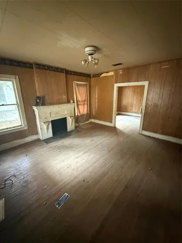 an empty room with windows and cabinet