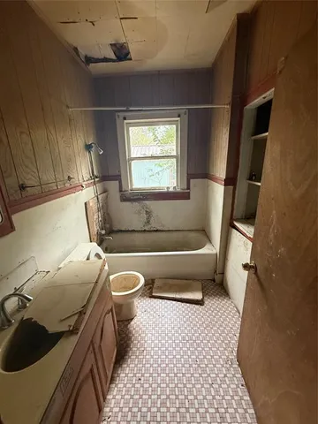 a bathroom with a bathtub sink and toilet
