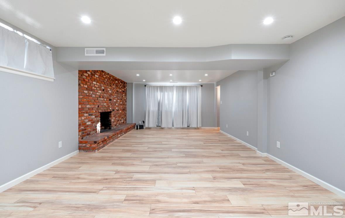 1775 Carlin Street Reno, NV 89503 - Photo 14 of 20 a view of an empty room with wooden floor fireplace and a window