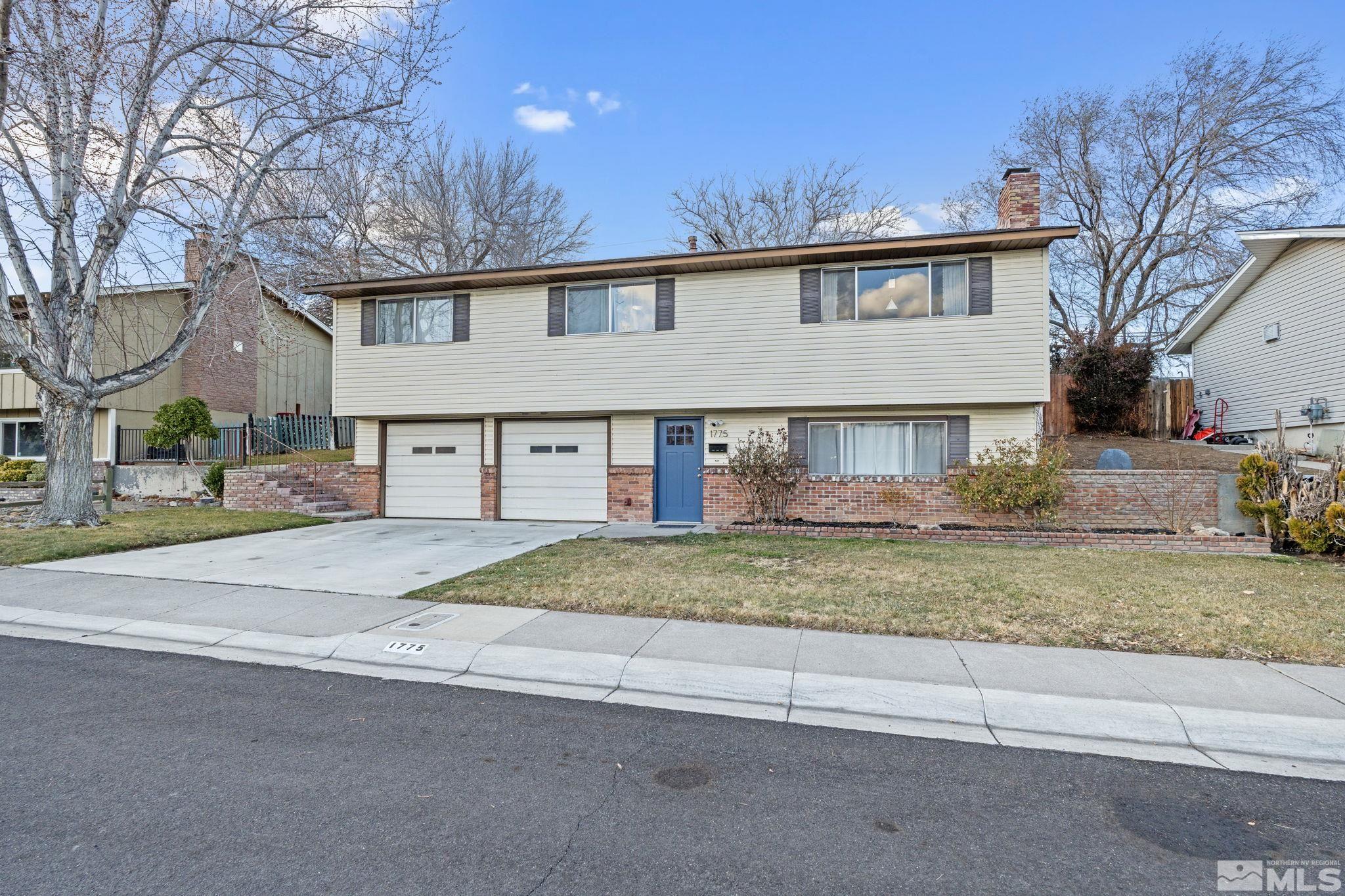1775 Carlin Street Reno, NV 89503 - Photo 2 of 20 a view of a house with a yard and garage