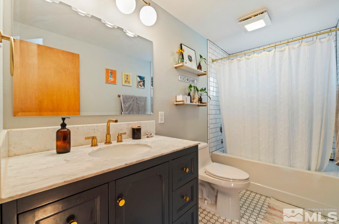 1775 Carlin Street Reno, NV 89503 - Photo 10 of 20 a bathroom with a sink a toilet and shower curtain
