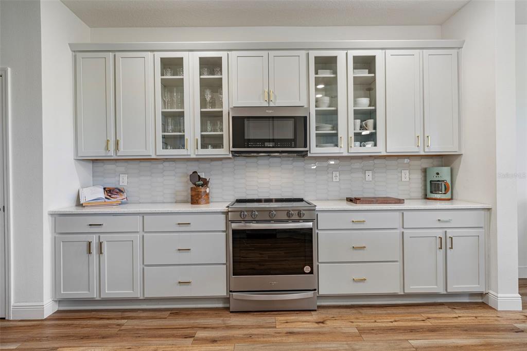 11430 Gallatin Trail Parrish, FL 34219 - Photo 26 of 79 a kitchen with stainless steel appliances granite countertop a stove and a microwave
