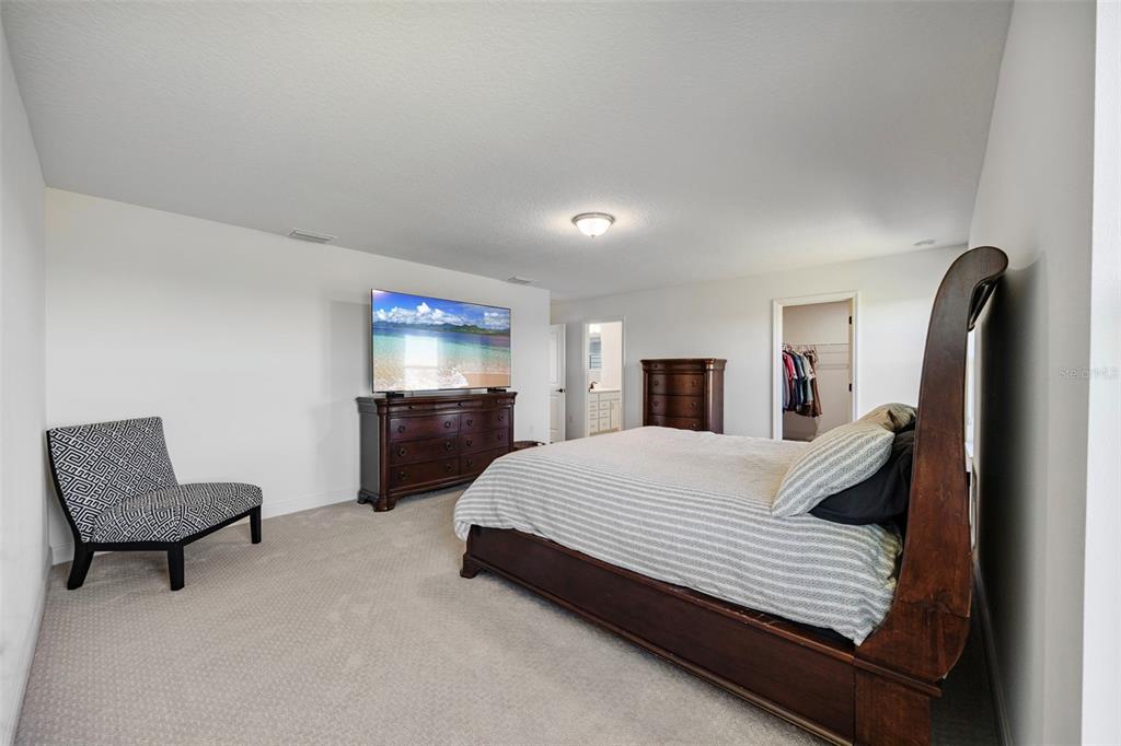 11430 Gallatin Trail Parrish, FL 34219 - Photo 32 of 79 a bedroom with a bed large mirror and couch