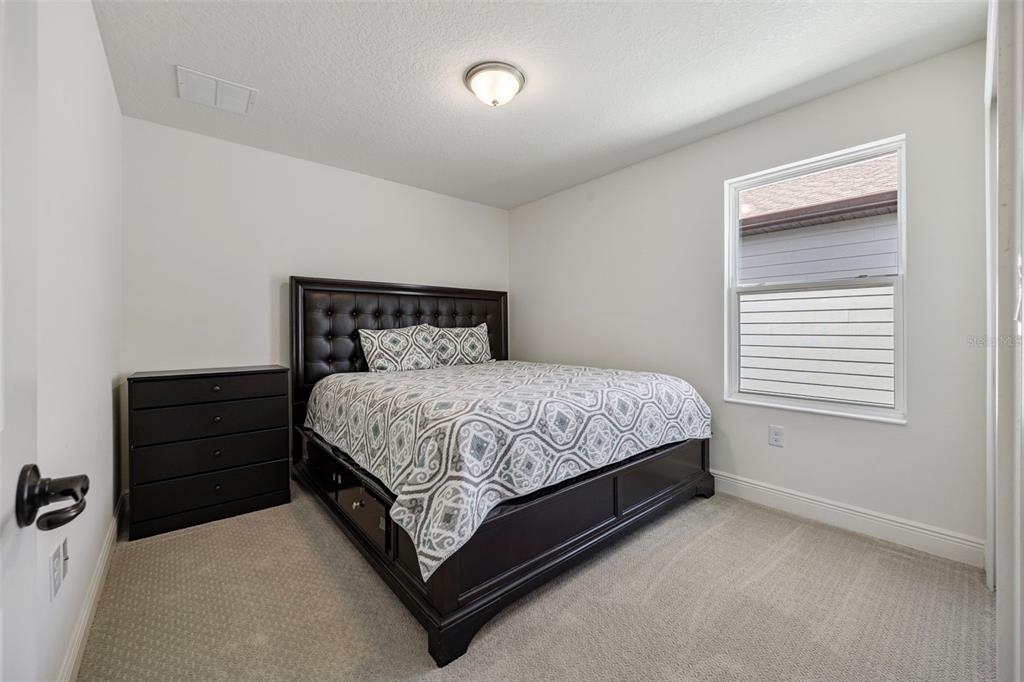 11430 Gallatin Trail Parrish, FL 34219 - Photo 38 of 79 a bed sitting in a bedroom next to a window