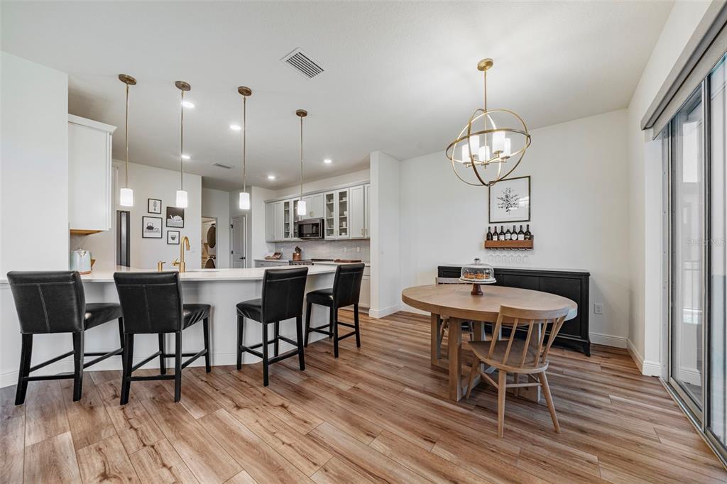 11430 Gallatin Trail Parrish, FL 34219 - Photo 4 of 79 a view of a dining room with furniture wooden floor and chandelier