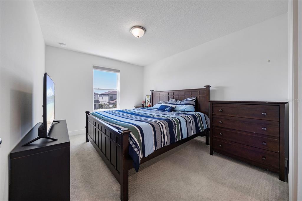 11430 Gallatin Trail Parrish, FL 34219 - Photo 42 of 79 a bedroom with a bed and flat screen tv