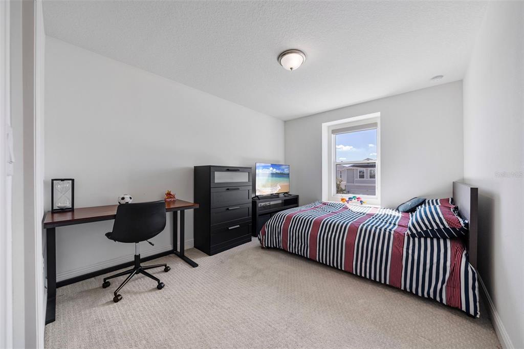 11430 Gallatin Trail Parrish, FL 34219 - Photo 44 of 79 a bedroom with a bed and a desk