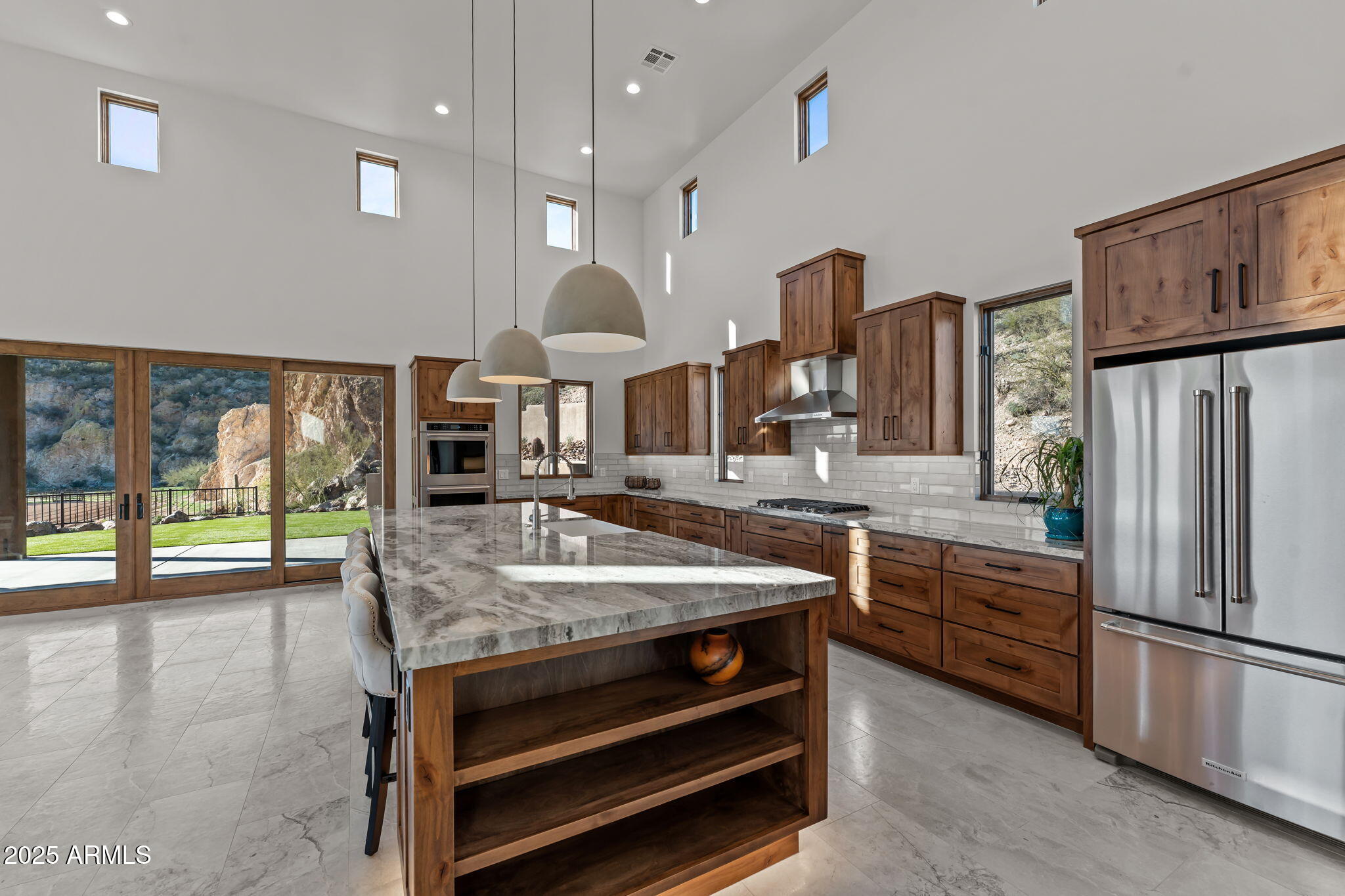 30100 Walter Road Wickenburg, AZ 85390 - Photo 11 of 66 a kitchen with stainless steel appliances granite countertop a stove a refrigerator and a refrigerator with wooden floor