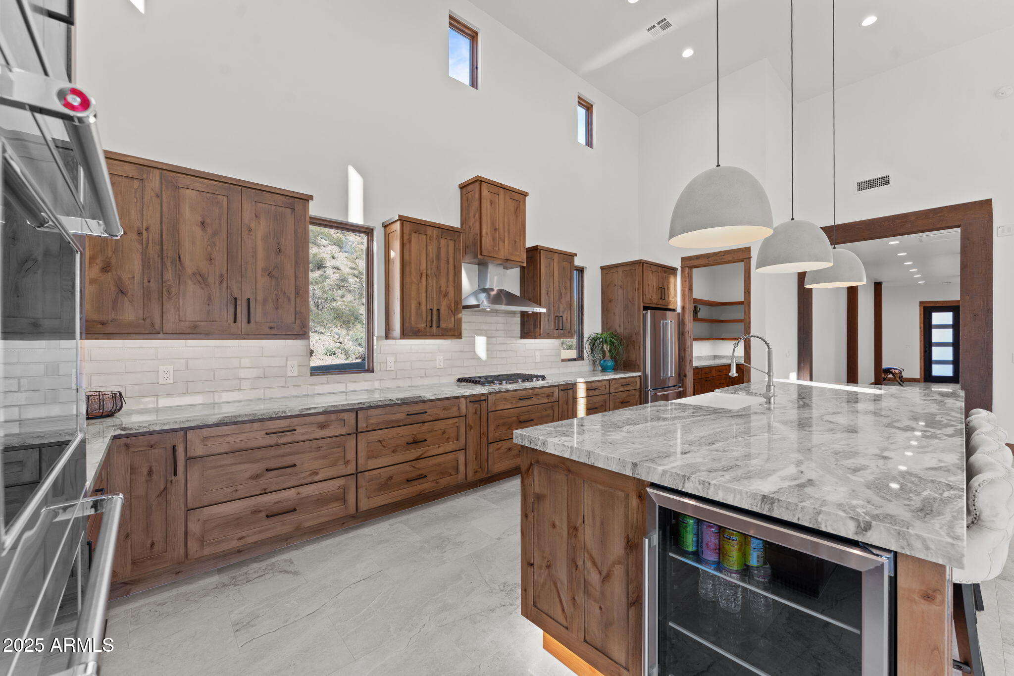 30100 Walter Road Wickenburg, AZ 85390 - Photo 14 of 66 a large kitchen with granite countertop a island a sink stainless steel appliances and cabinets
