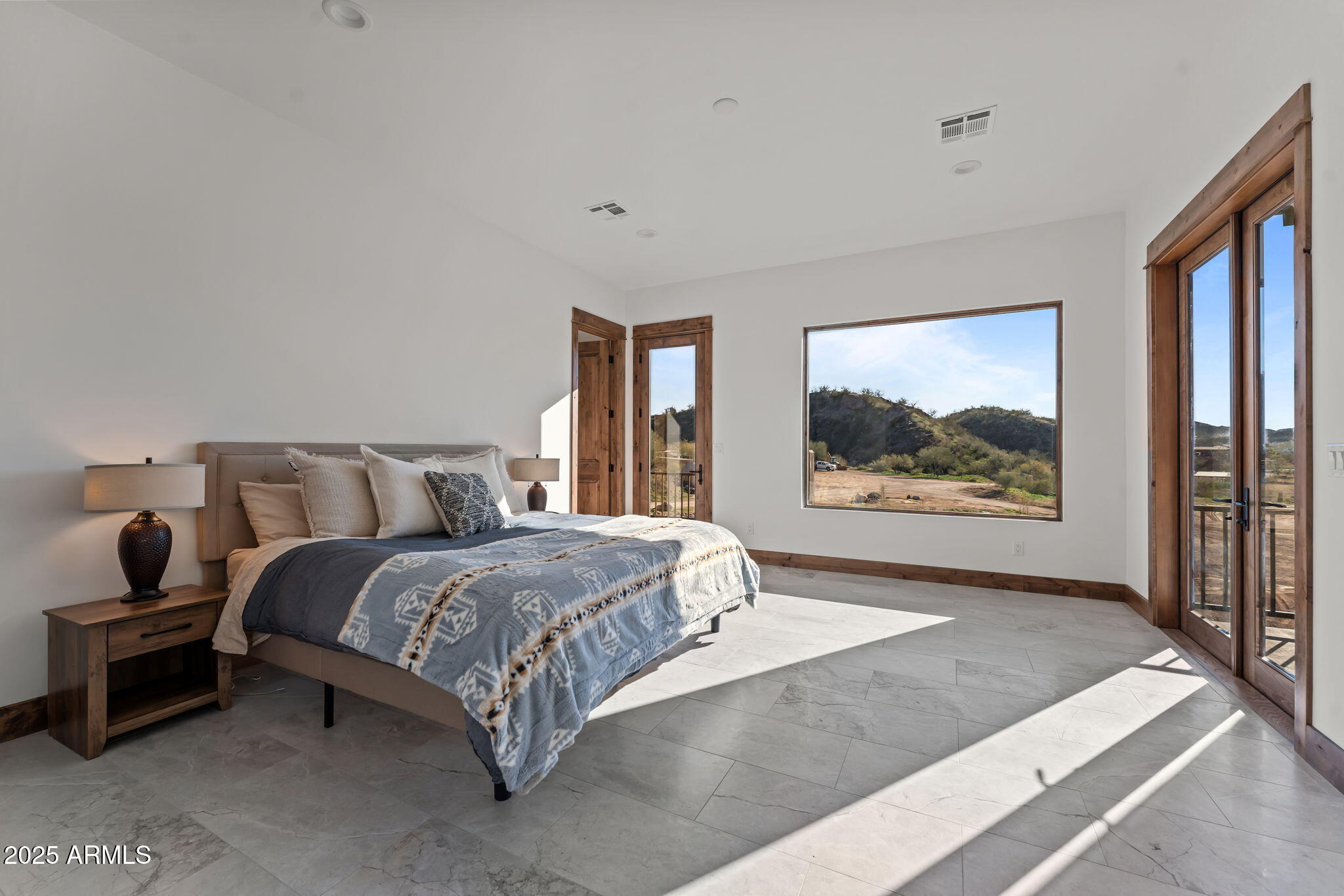 30100 Walter Road Wickenburg, AZ 85390 - Photo 32 of 66 a bedroom with a bed and a painting on the wall