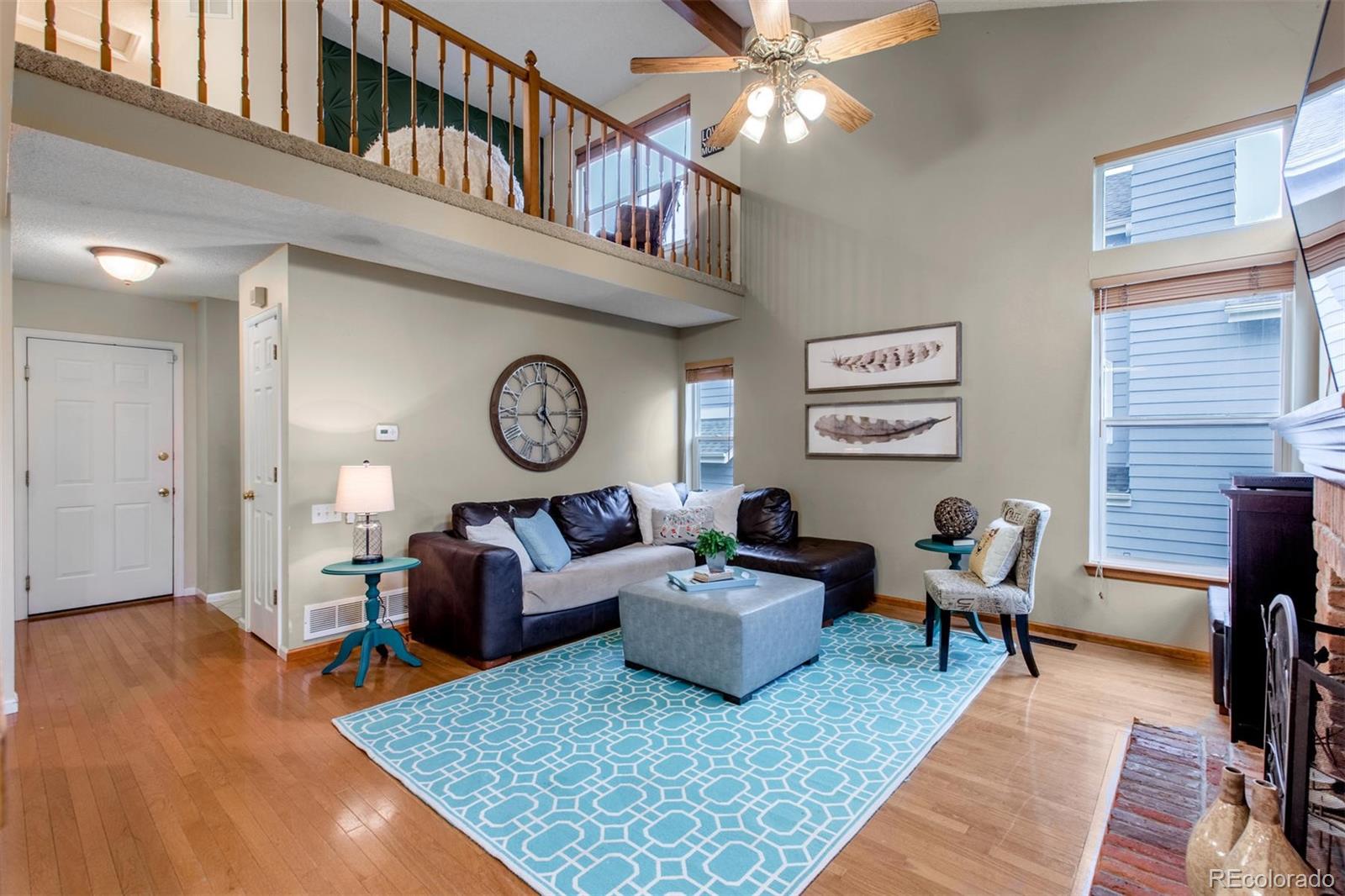 10037 Hooker Street Westminster, CO 80031 - Photo 13 of 40 a living room with furniture and a clock