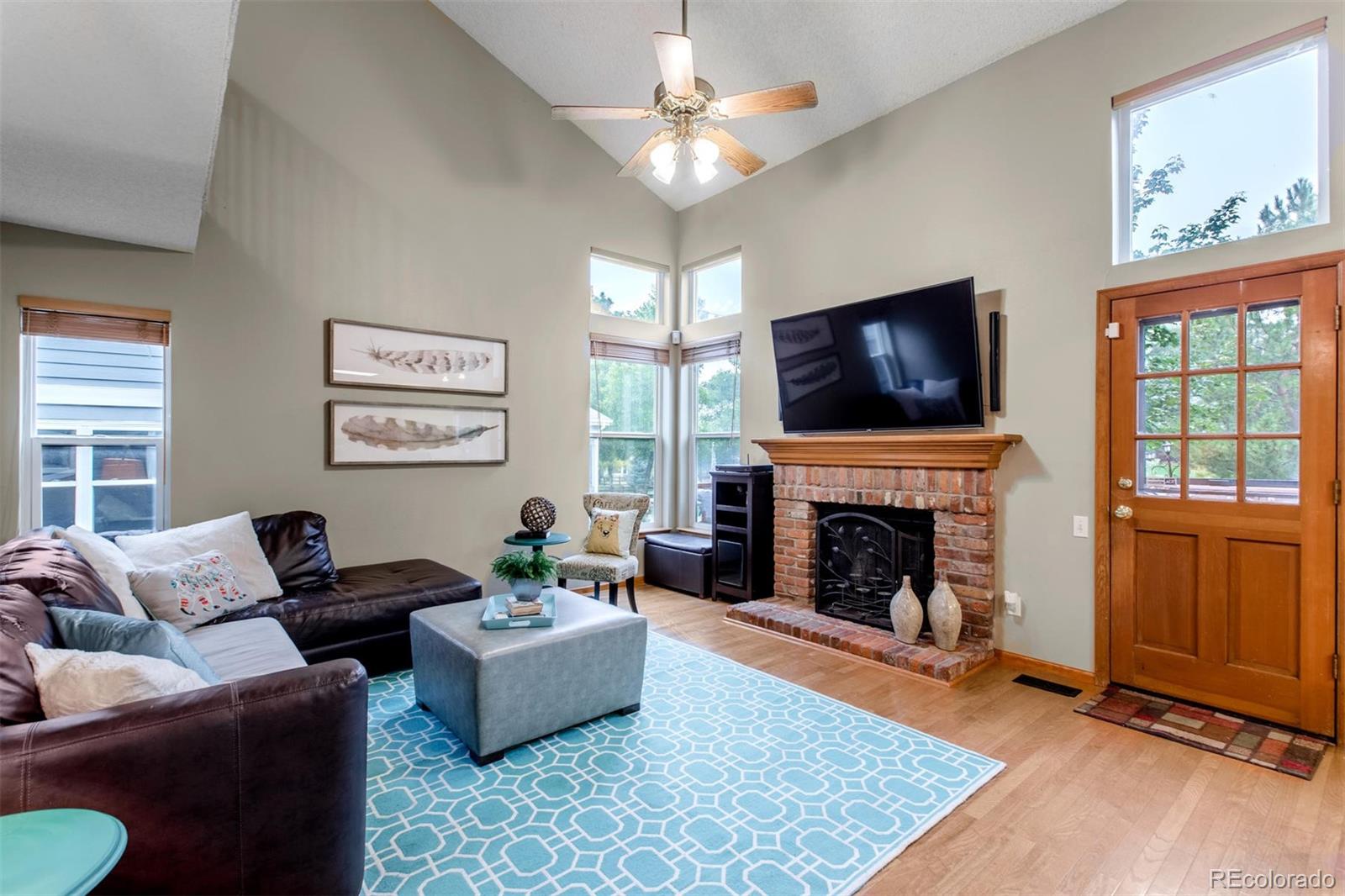 10037 Hooker Street Westminster, CO 80031 - Photo 14 of 40 a living room with furniture a flat screen tv and a fireplace